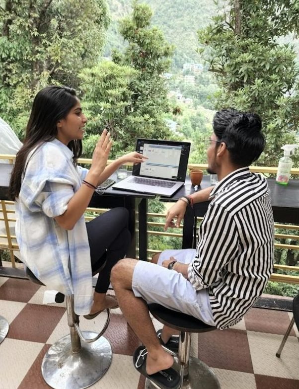 Two students reviewing a campaign dashboard on a laptop